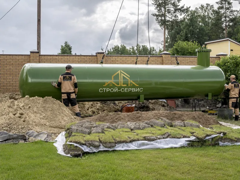 Зелёный горизонтальный газгольдер на стропах над котлованом